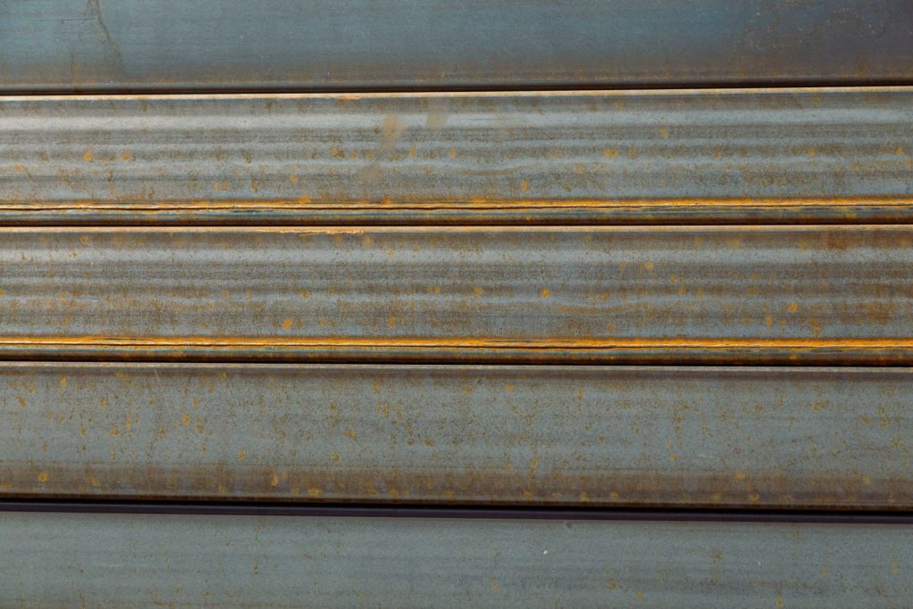 Detailed texture of rusty gray sheet metal for backgrounds or design.